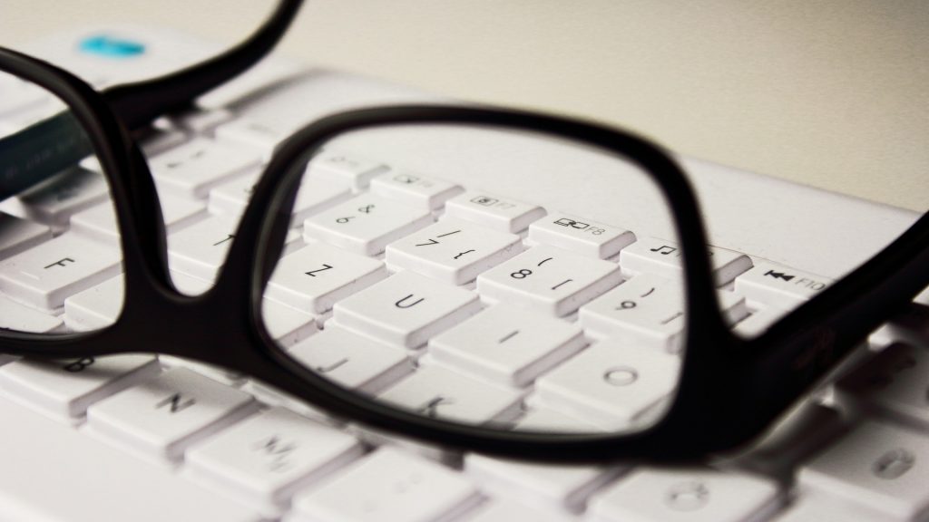 glasses resting on a computer keyboard